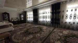 a living room with a large rug and windows at Дом  +5 photos