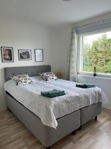 a bedroom with a large bed with a window at Happy house in Helsinki