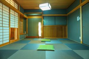 an empty room with mats on the floor at Nagoya Apartment Oosu in Minami-sotoborichō