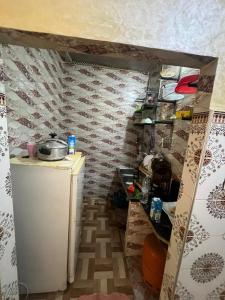 a small kitchen with a sink and a refrigerator at ezzaimi apartment playa in Tangier