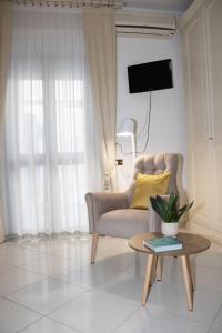 a living room with a chair and a table at Chicca Casa Vacanze in Casarano