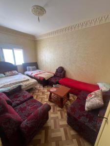 a living room with a couch and a table at ezzaimi apartment playa in Tangier
