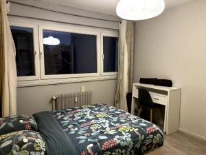 a bedroom with a bed and a desk and a window at Yellow Room - Coloc Cursat in Annemasse