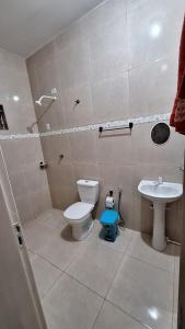 a bathroom with a toilet and a sink at Casa temporada Martins,RN in Martins