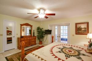 a bedroom with a bed and a ceiling fan at Riverfront Dunnellon Home with Private Dock! in Dunnellon