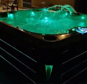a bath tub filled with water in a room at N-Joy Aruba in Cunucu Abao
