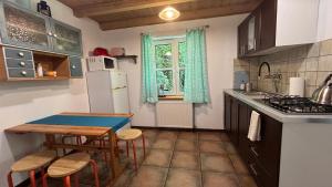 a kitchen with a table and a small table and chairs at Mandarynkowy in Dębki