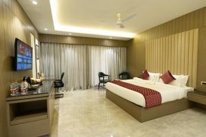a hotel room with a bed and a desk at Pride Resort Jodhpur in Banār