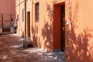 an alley with a shadow of a building at Italian Experience- Aselli Home in Pavia