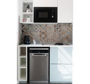 a kitchen with a microwave and a dishwasher at Italian Experience- Aselli Home in Pavia