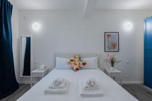 a bedroom with a large white bed with two tables at Italian Experience- Aselli Home in Pavia
