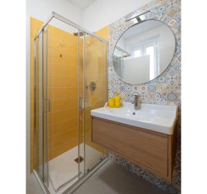 a bathroom with a sink and a mirror at Italian Experience- Aselli Home in Pavia +29 photos