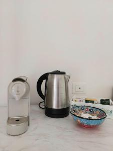 a tea kettle and a bowl on a counter at L'acero in La Spezia +10 photos