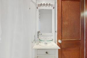 a bathroom with a sink and a mirror at Mermaid Cottage in Falmouth +9 photos