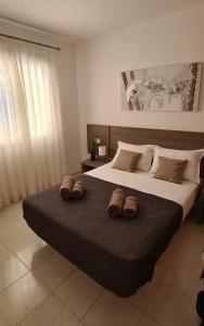 a bedroom with a large bed with two slippers on it at Case Sunny Calpe in Calpe +9 photos