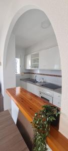 a kitchen with white cabinets and a wooden counter top at Case Sunny Calpe in Calpe