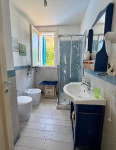 a bathroom with a toilet and a sink and a shower at Marilù Casa Vacanza in San Vito lo Capo +28 photos