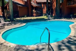 a large blue swimming pool in front of a house at Woodlands 34 in Mammoth Lakes