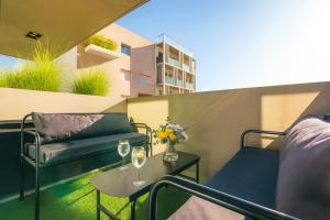 a balcony with a table and two glasses of wine at Deluxe Apartments in Palermo - by BueRentals in Buenos Aires