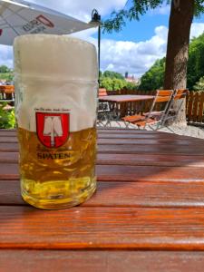 ein Glas Bier auf einem Holztisch in der Unterkunft Hotel Burgblick Meißen in Meißen