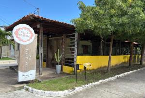 a building with a sign in front of it at Apart Atalaia ar cond 2 qtos in Aracaju