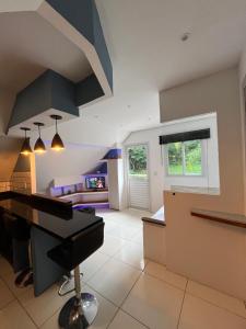 a living room with a piano in a room at Casa Figueira na Pedra - SPA Suites in Florianópolis