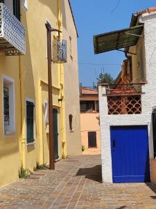 a blue door on the side of a building at Sanceflo in Mandelieu-La Napoule +4 photos