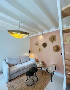 a living room with a couch and some chairs at Le petit Cosy in Le Touquet-Paris-Plage +2 photos