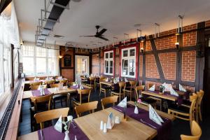 a dining room with wooden tables and chairs at Altora Eisenbahn Themenhotel in Wernigerode