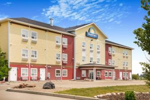 a hotel with a red and yellow building at Days Inn by Wyndham Lamont in Lamont