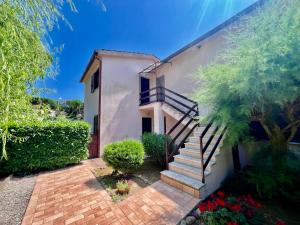 a house with a staircase in front of it at RESIDENZA RIO ELBA - Elba Affitti in Rio nellʼElba
