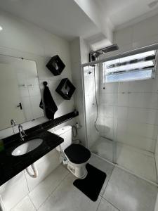 a bathroom with a toilet and a sink and a shower at Apartamento WJM in Espirito Santo Do Pinhal