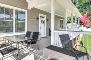 a screened porch with a table and chairs on a house at Modern Tims Ford Lake Home with Private Dock and Pool! in Lynchburg