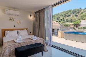 a bedroom with a bed and a balcony with a pool at La Vue, Suites For Living in Zakynthos Town