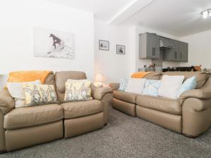 a living room with two couches and a couch at 76A Mackworth Road in Porthcawl +27 photos