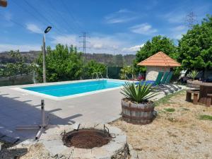 a swimming pool in a yard with a table and a bench at Bungalow da Pedreira in Viseu