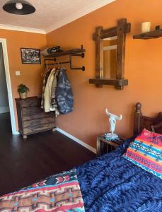 a bedroom with a bed and a dresser and a mirror at Western style living in Telscombe
