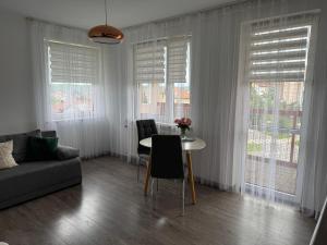 a living room with a couch and a table with chairs at Studio G44 in Gdynia
