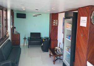 a living room with a couch and a chair at Ver A Vista Hotel in Araruama