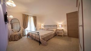 a bedroom with a bed and a mirror at Villa degli Olivi in Crespina +42 photos