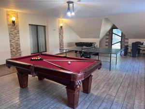 a room with a pool table and two ping pong tables at Pensiunea Select Moeciu in Moieciu de Sus