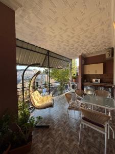 a living room with a balcony with a table and chairs at Sunny Days in Kobuleti