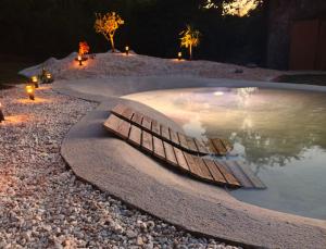 a pool of water with a wooden boat in it at as Alvarizas in Moraña