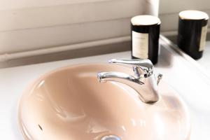 a sink with a faucet and two bottles of soap at Elegant Central Vincennes Paris in Vincennes +15 photos