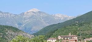 a mountain in the distance with a town in the foreground at B&B La Foglietta in Paganica +10 photos