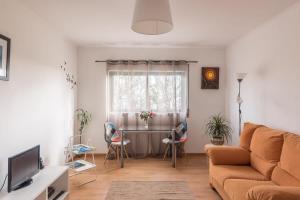 a living room with a couch and a table at SMOOTH T3 APARTMENT in Ponta Delgada