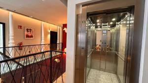 a glass door leading to a walk in shower at Literal Hostel Madrid in Madrid