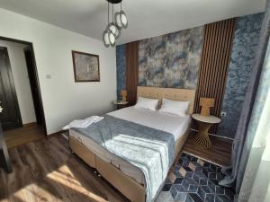a bedroom with a bed and a chandelier at Apartament Stefania Targu Ocna in Târgu Ocna