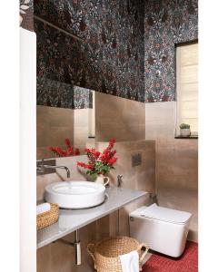 a bathroom with a sink and a toilet at Hillside Home 3 BHK Villa by tisyastays in Yedapalli +26 photos