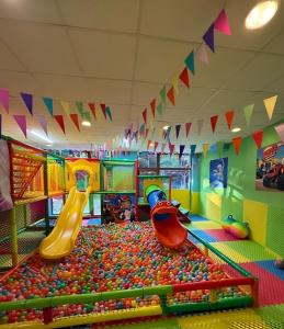 a childrens play room with a slide and balls at Hotel Iceberg Borovets in Borovets +96 photos
